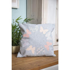 Sizzix Bigz Die Garden Wings by Olivia Rose cutting dies; blue-gray woven pillow with pastel butterfly shapes.