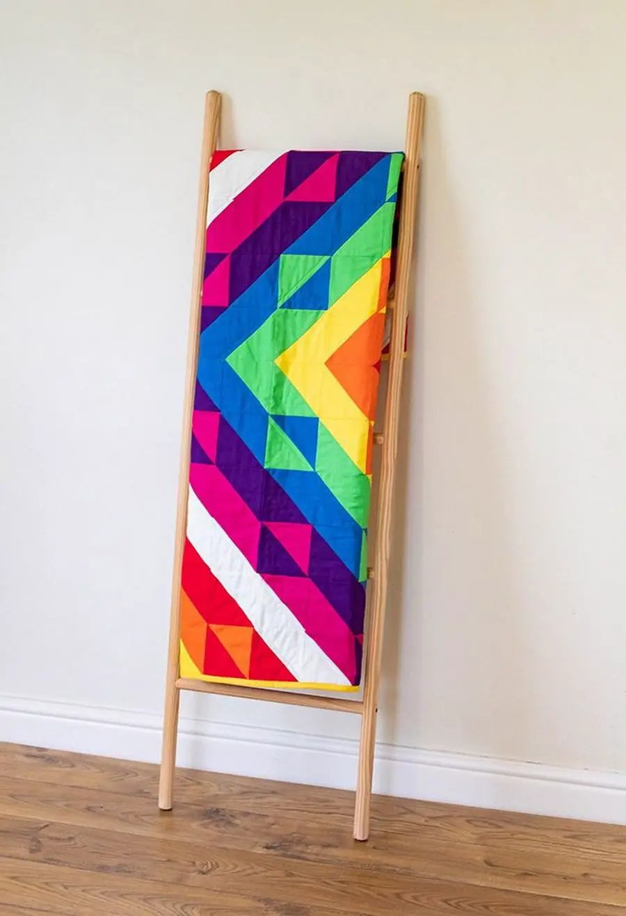 Crafters Companion Threaders Shape Creator cutting mats, vibrant geometric quilt on wooden stand