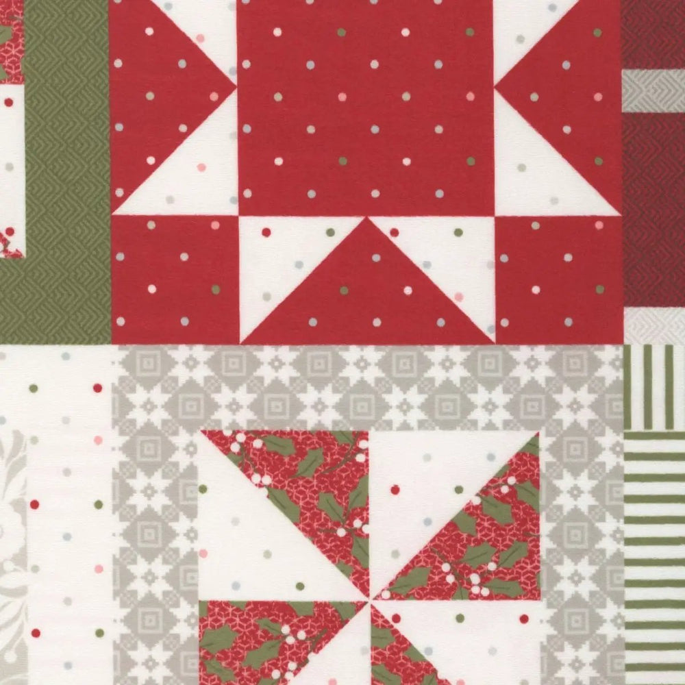 Christmas patchwork quilt fabric featuring red, green, white, and gray geometric blocks with stars, pinwheels, holly prints, stripes, and festive patterns.