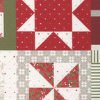 Christmas patchwork quilt fabric featuring red, green, white, and gray geometric blocks with stars, pinwheels, holly prints, stripes, and festive patterns.