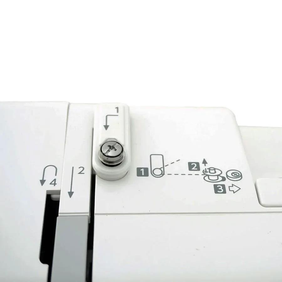 Janome DC2019 computerized sewing machine with free bundle package, white body, top-view of bobbin area