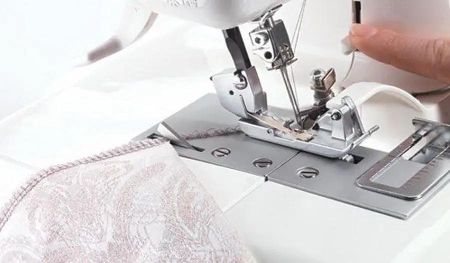 Husqvarna Viking Amber S100 serger sewing machine, white metal construction with chrome accents.
