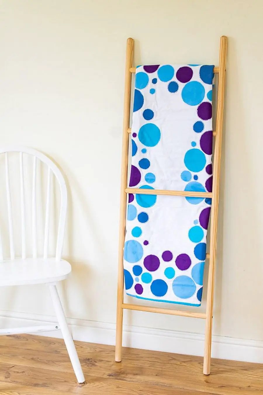 Crafters Companion Threaders Shape Creator cutting mat on a wooden stand with blue and purple polka-dot fabric.
