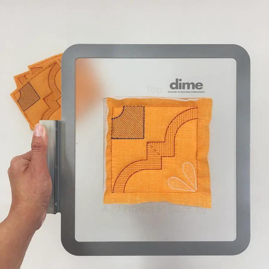 DIME Monster Block Maker hooping aid with orange fabric patch and single-needle setup