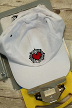 DIME Magnetic Hoop Clips cap white with red heart embroidery inside a black ornamental circle.