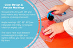 Grace TrueCut 90° Right Angle Ruler; transparent grid ruler on orange cutting mat with blue rotary cutter in use.