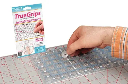 Grace TrueCut True Grips quilting grips by Grace Company on a clear ruler