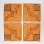 DIME Monster Block Maker quilt blocks: four orange squares with brown geometric stitching.