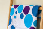 Crafters Companion Threaders fabric with blue and purple circular prints on white, draped over a wooden rack.