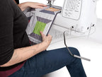 Singer 8500Q Modern Quilter sewing machine with white body quilting a patchwork quilt