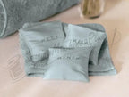 SINGER 8500Q Modern Quilter accessories: three light-blue sachets labeled REST RELAX RENEW on a soft towel