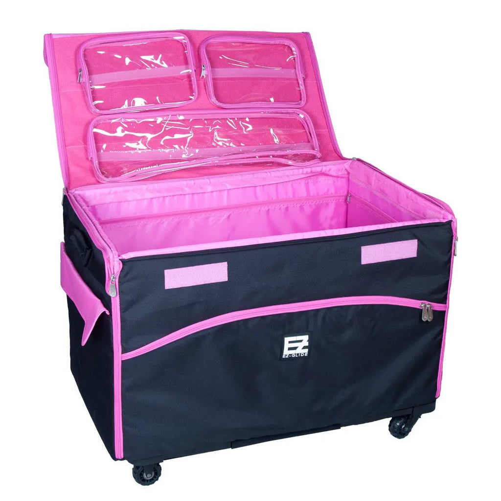 29-inch EZ-Glide trolley machine bag, black with pink interior and clear lid pockets; EZ-Glide logo visible.