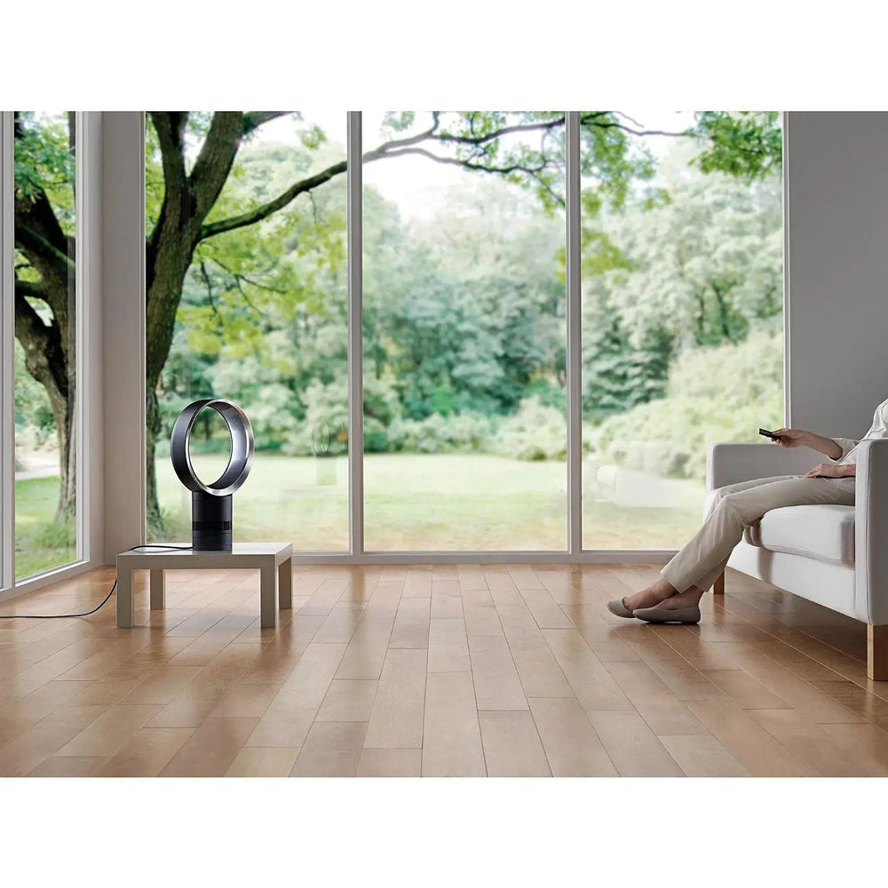 Dyson AM06 10in desk fan in white with bladeless ring on a small table