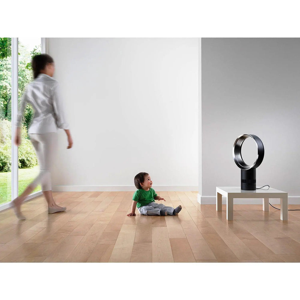 Dyson AM06 10-inch desk fan in white with black base on a white table