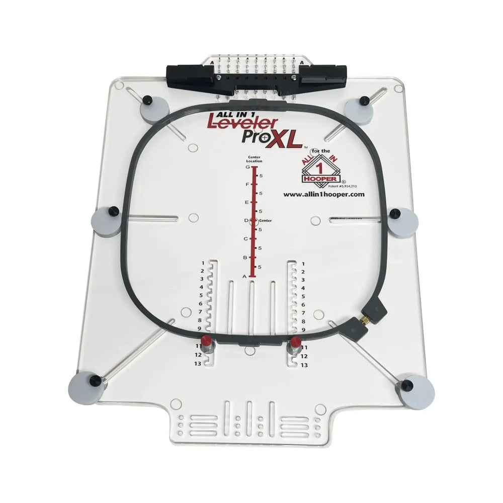 All in 1 Hooper Pro Starter Kit hooping aid on a white acrylic base with a black circular hoop and measurement scales by Tex Inc