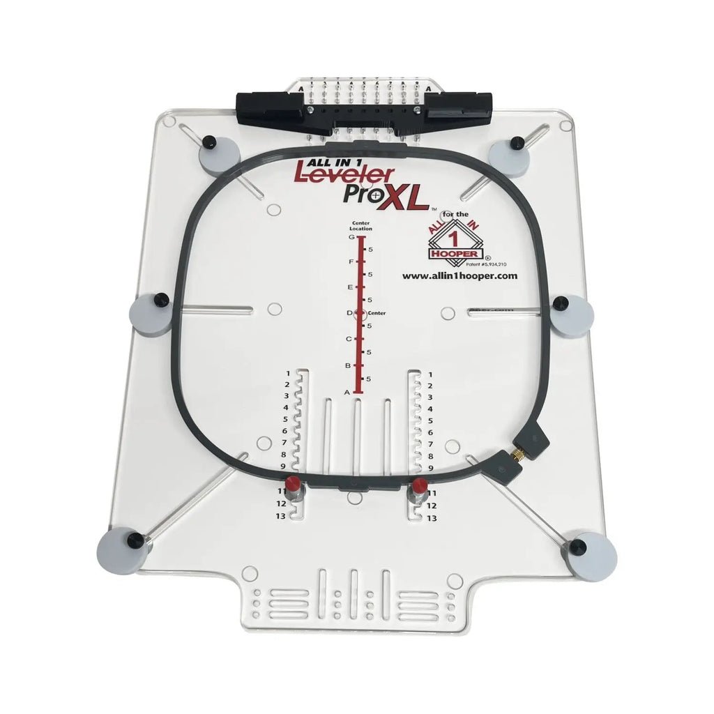 All in 1 Hooper Pro Starter Kit hooping aid on a white acrylic base with a black circular hoop and measurement scales by Tex Inc