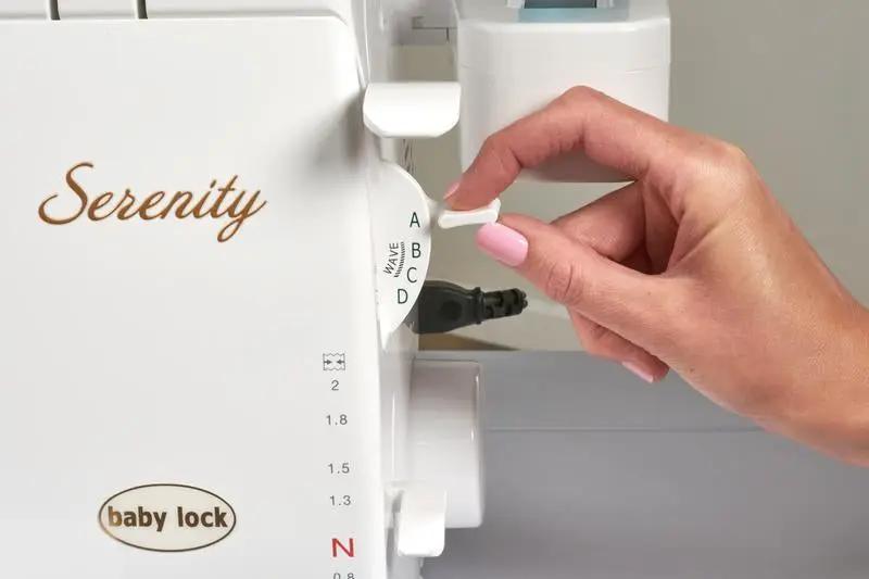 Baby Lock Serenity 4-thread serger; white machine with tension dials A–D and Serenity logo.