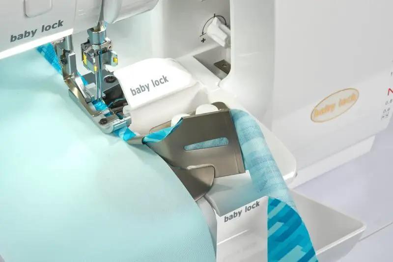Baby Lock Serenity 4-Thread Serger sewing machine with white body and teal fabric under the presser foot.