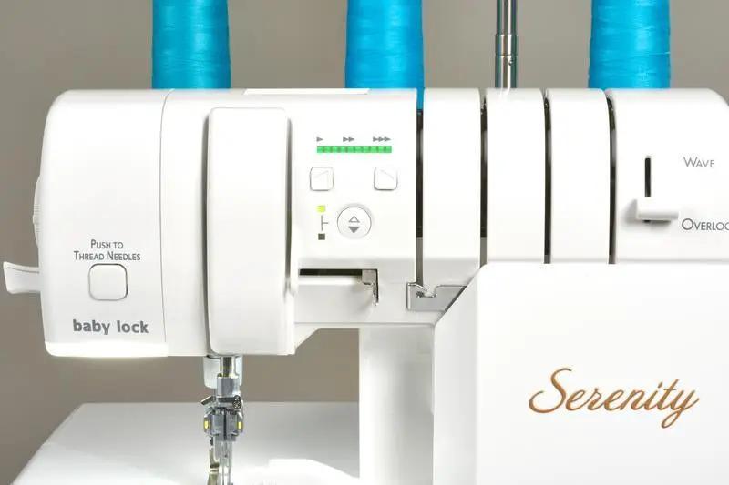 Baby Lock Serenity 4-Thread Serger sewing machine, white body with blue thread spools on top.