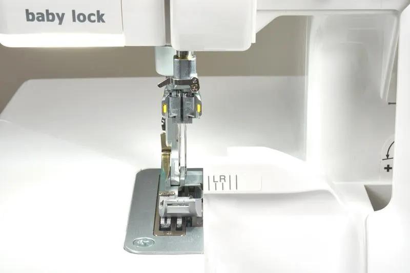 Baby Lock Serenity 4-Thread Serger sewing machine; brand logo visible, close-up of needle and presser foot.