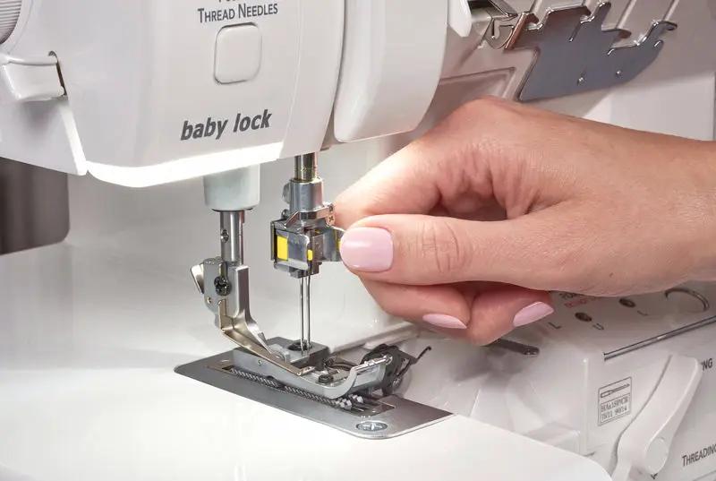 Baby Lock Serenity 4-Thread Serger; white serger with hand threading the needle