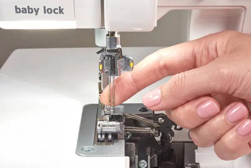 Baby Lock Serenity 4-Thread Serger sewing machine; white body with hand threading the needle area.