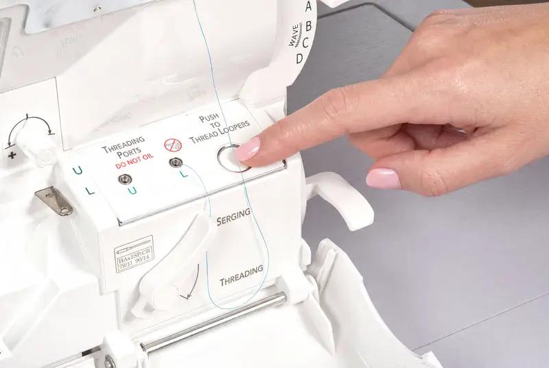Baby Lock Serenity 4-Thread Serger in white, finger pressing threading control