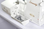 Baby Lock Serenity 4-Thread Serger, white serger with tension dials and front storage tray.