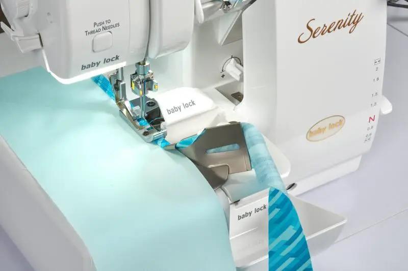 Baby Lock Serenity 4-Thread Serger with teal fabric under the presser foot.