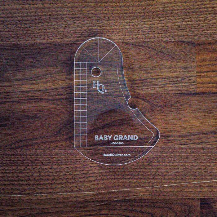 Baby Grand Quilting Ruler, clear acrylic piano-shaped quilting tool by Handi Quilter with grid markings.