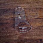 Baby Grand Quilting Ruler, clear acrylic piano-shaped quilting tool by Handi Quilter with grid markings.