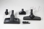 The Bank Robber Canister Vacuum in black with floor nozzle, brush tool, crevice tool, and small nozzle attachments