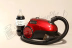 The Bank Robber Canister Vacuum, red with flexible hose and brush attachment
