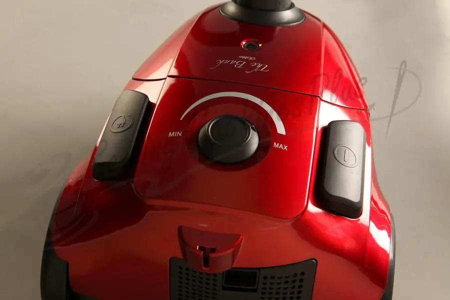 The Bank Robber Canister Vacuum, red with black handles and a MIN–MAX control dial.