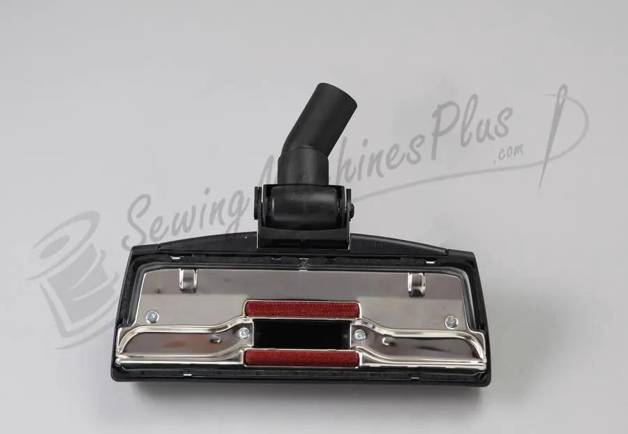 The Bank Robber canister vacuum head; black plastic with chrome plate and red brush strips