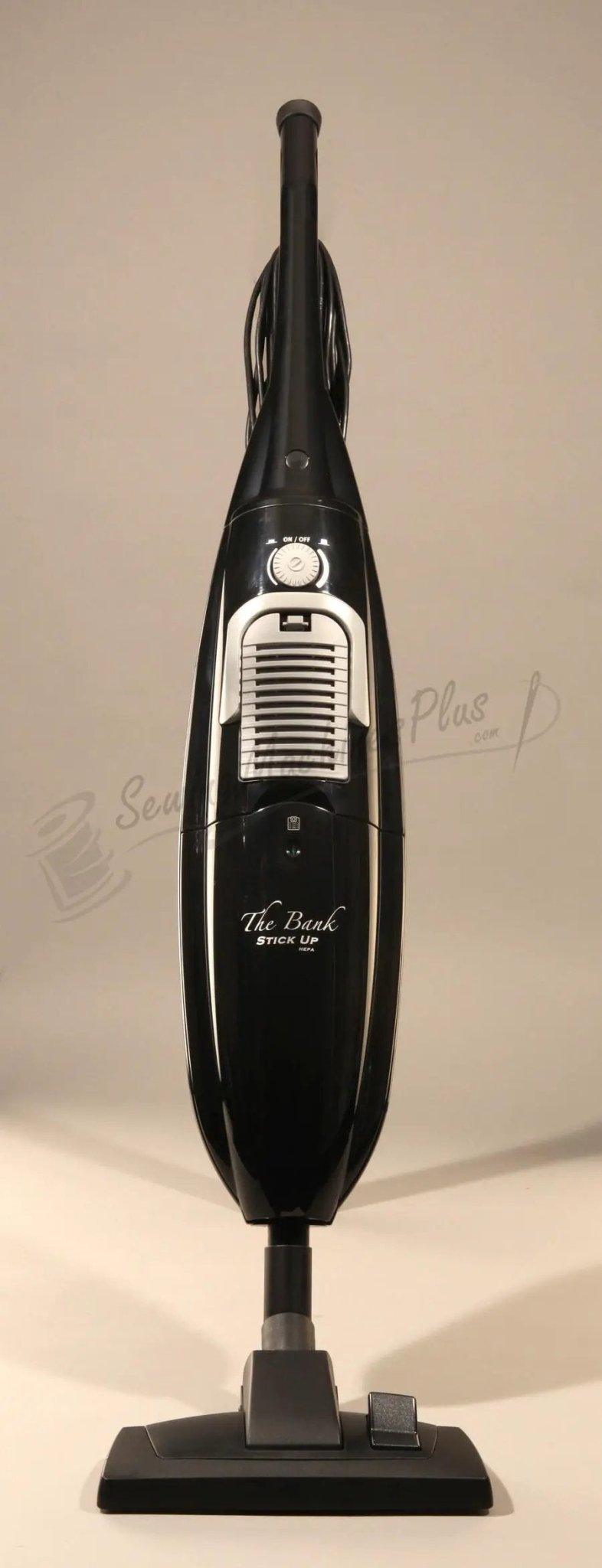 The Bank Stick Up HEPA hard-floor vacuum; black upright handheld with cord and white vent.