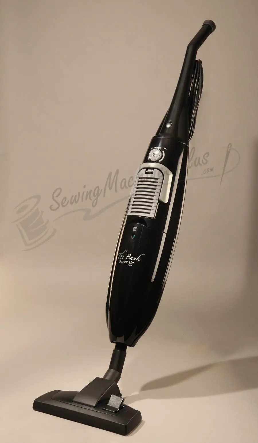 The Bank Stick Up HEPA hard-floor vacuum, black upright vacuum with cord.
