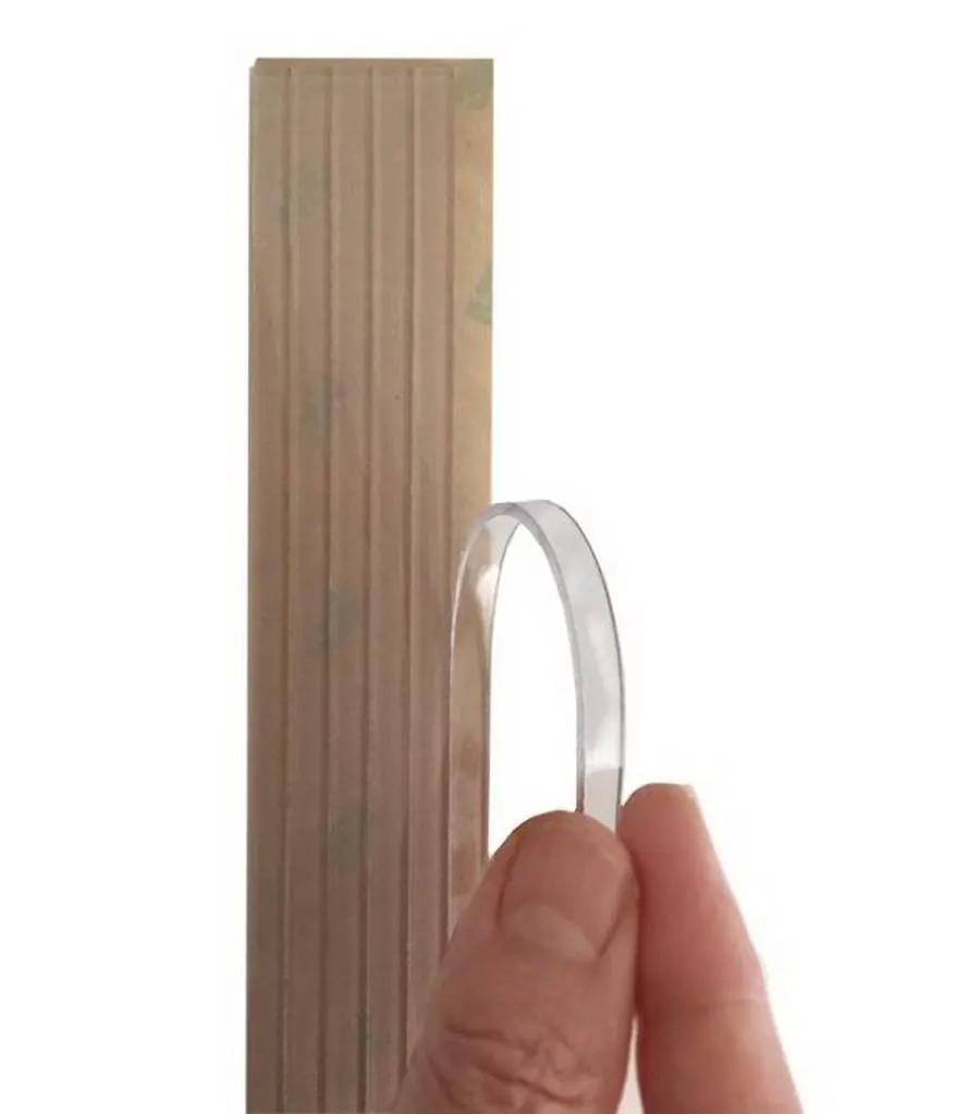 Grip Strips by Guidelines 4 Quilting; clear plastic grip strip shown beside a wooden ruler.