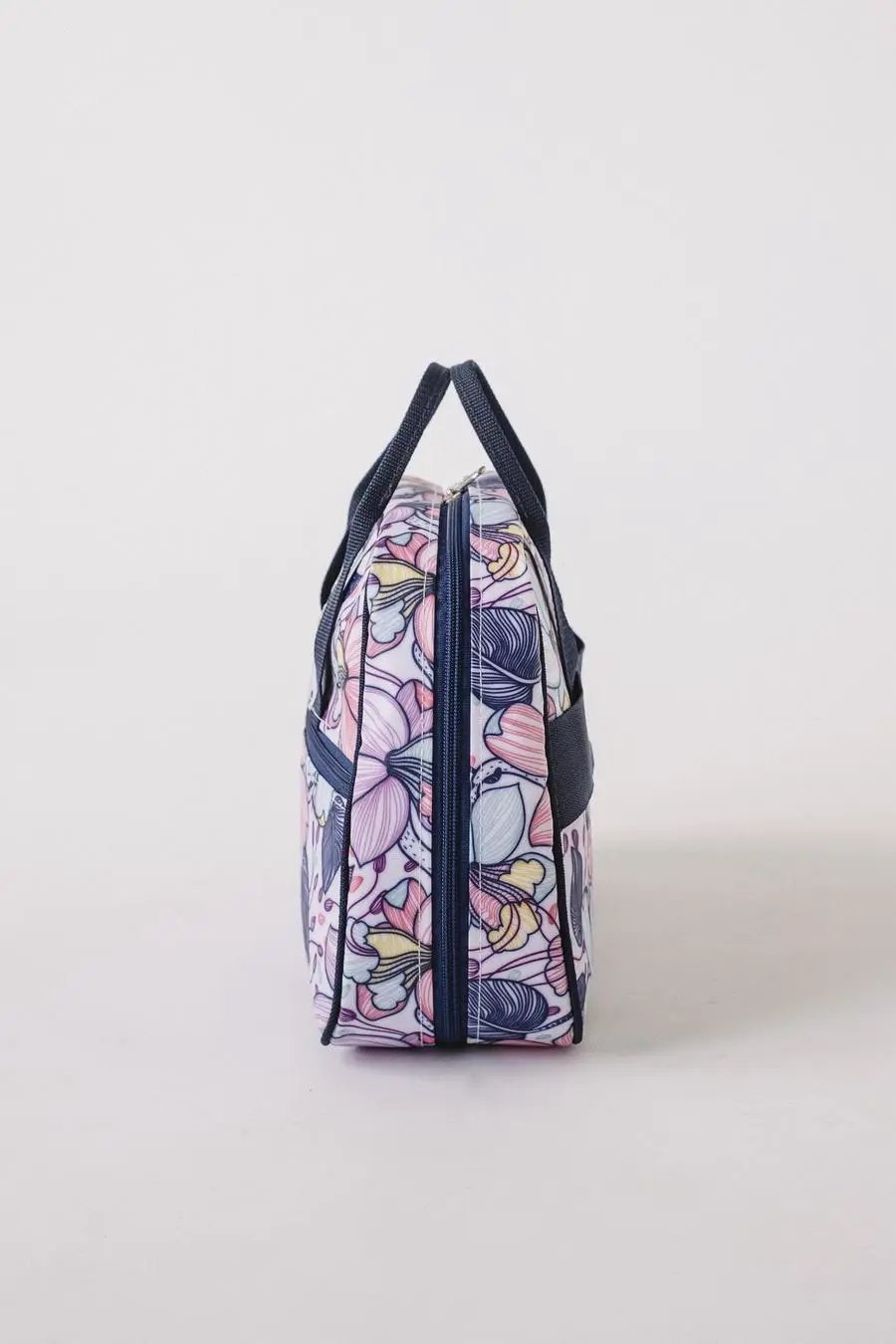 Bluefig Quilter Deluxe Combo bag in pastel floral fabric with navy handles