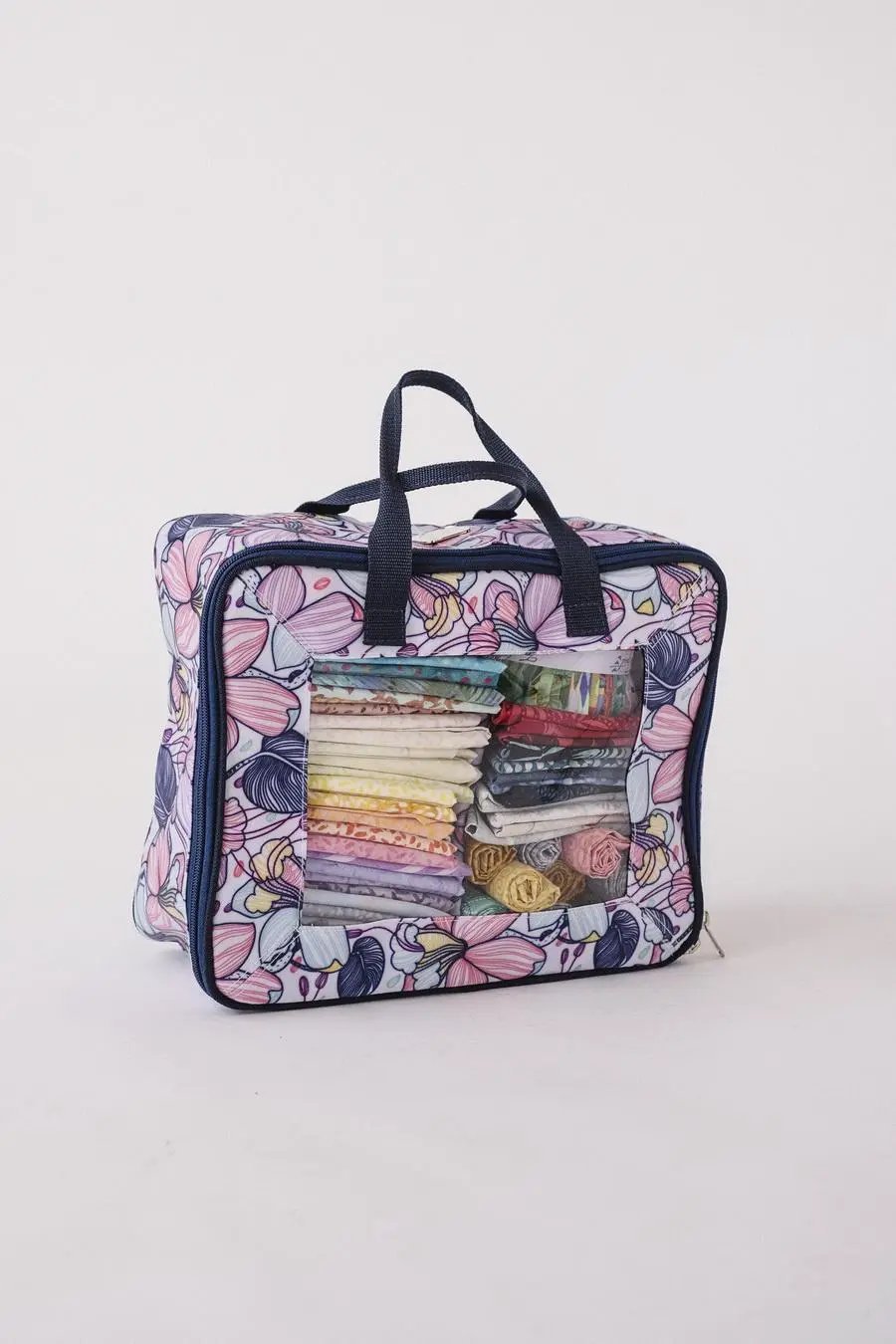 Bluefig Quilter Deluxe Combo machine bag with floral print and clear front window showing fat quarter bundles