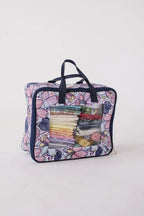 Bluefig Quilter Deluxe Combo machine bag with floral print and clear front window showing fat quarter bundles