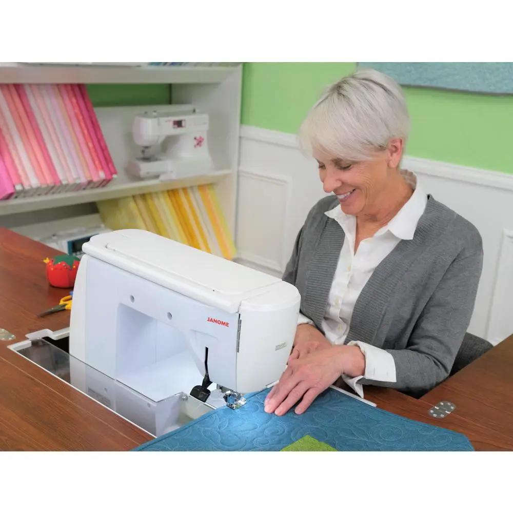 Sewing cabinet set by Kangaroo Sewing Furniture with a white Janome sewing machine.
