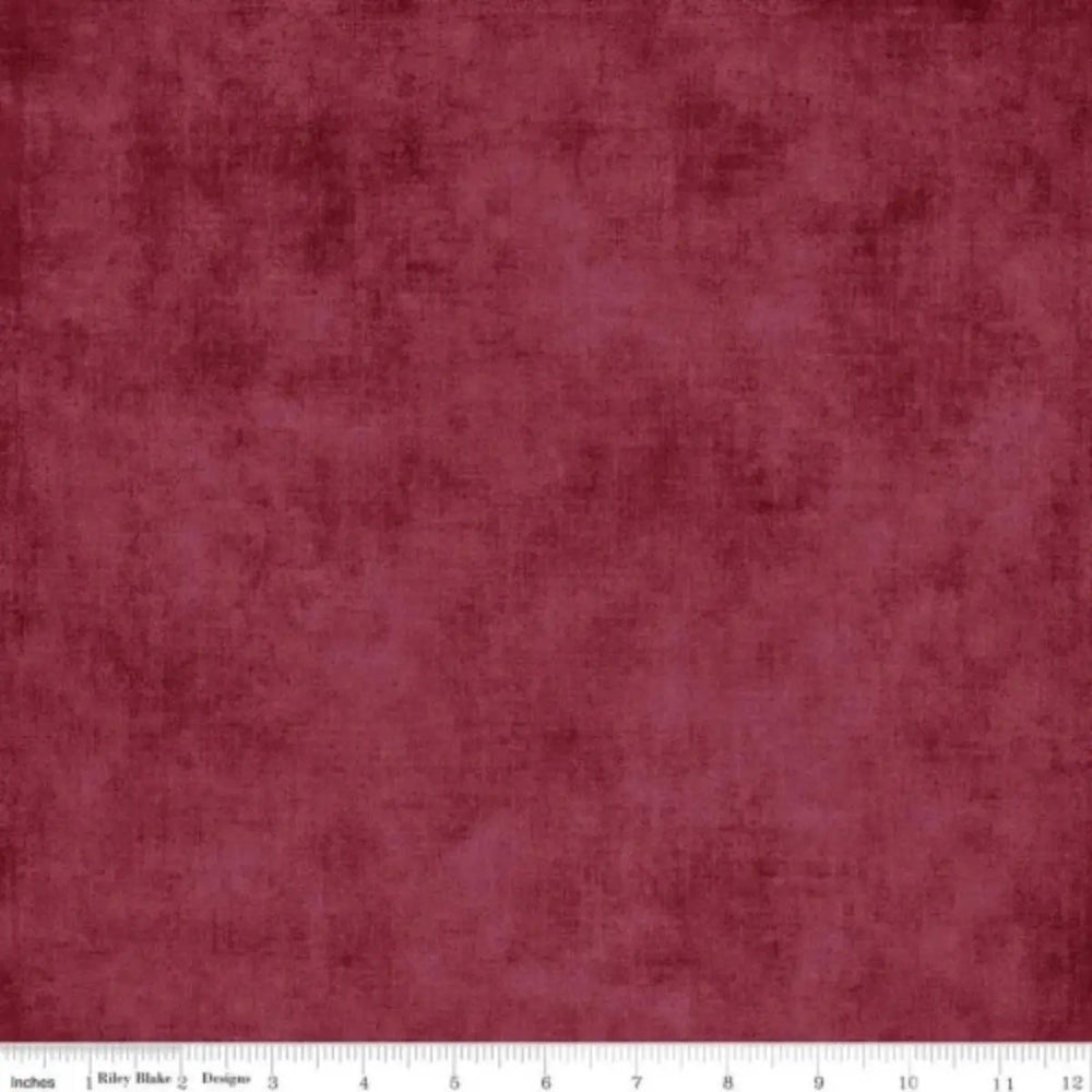 Shades Burgundy quilting cotton fabric with a deep burgundy mottled tonal texture by Riley Blake Designs.