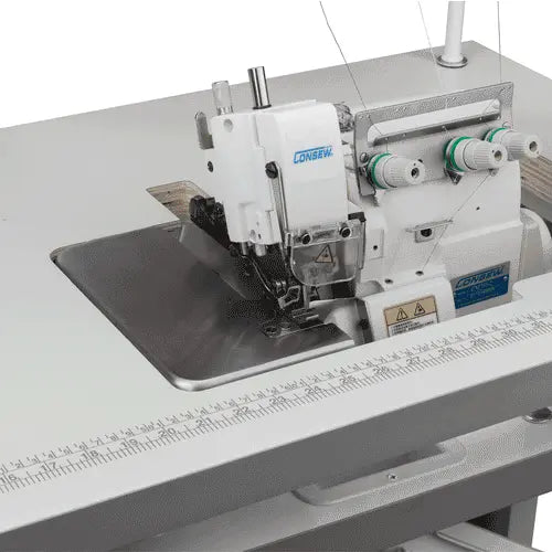 Consew CM793 serger with assembled table and servo motor; white machine with green-thread spools.