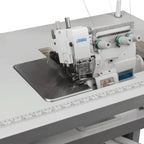 Consew CM793 serger with assembled table and servo motor; white machine with green-thread spools.