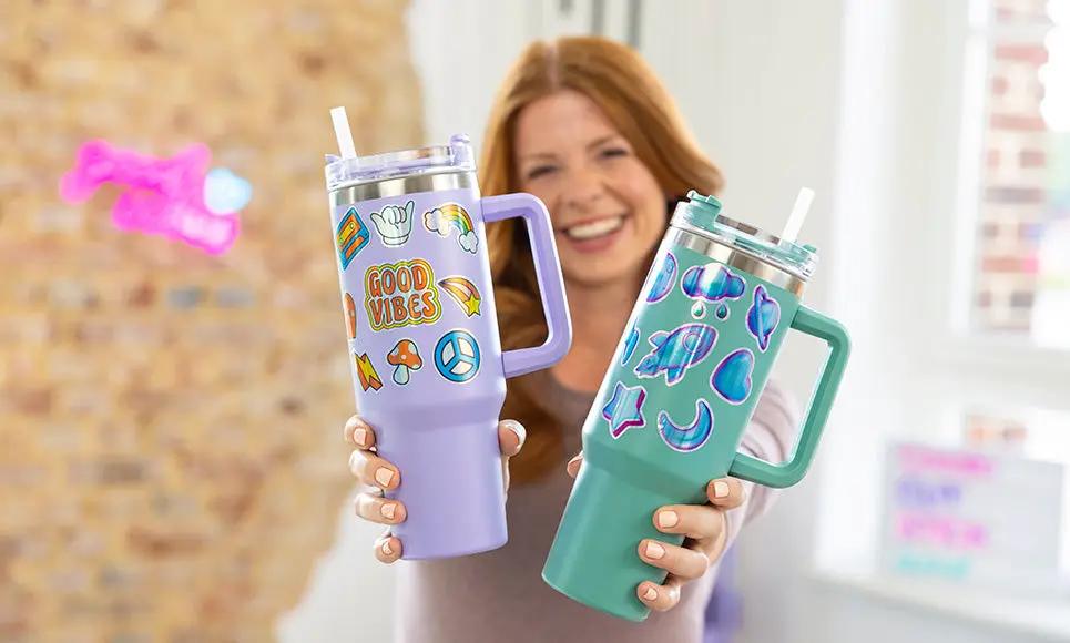 Brother Bellissimo CT1 Cutting Machine; two pastel purple and teal travel tumblers with stickers held by a smiling woman