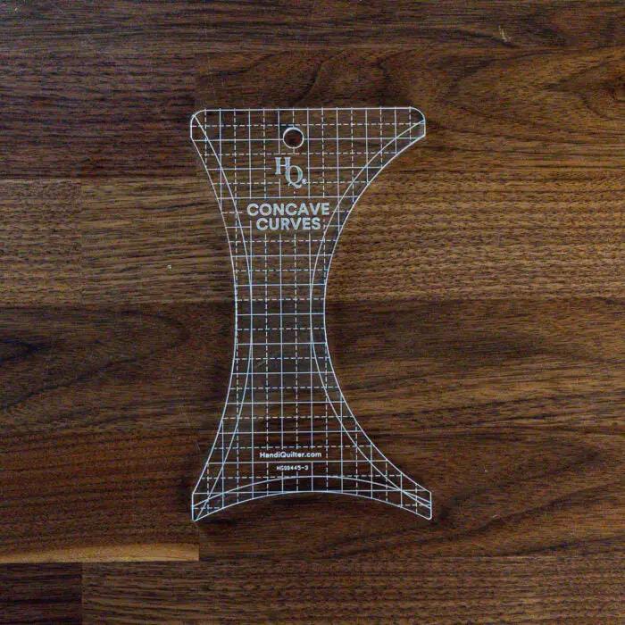 Handi Quilter Concave Curves Ruler, a clear acrylic quilting ruler with grid pattern