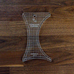 Handi Quilter Concave Curves Ruler, a clear acrylic quilting ruler with grid pattern
