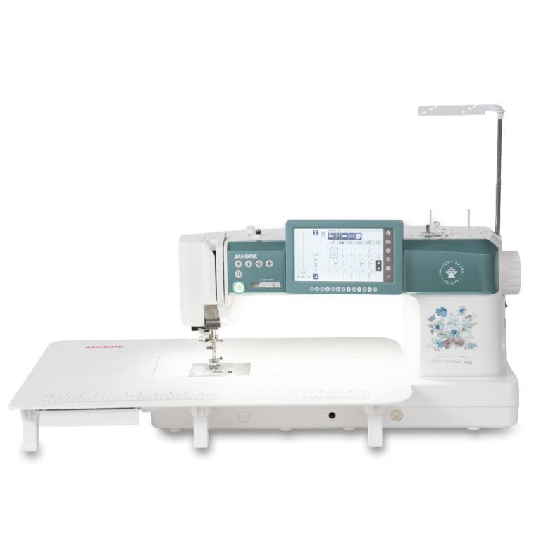 Janome Continental M6 sewing and quilting machine with teal control panel and detachable extension table.