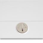 Janome sewing machine control dial on white surface; metallic round knob with arrows and plus/minus